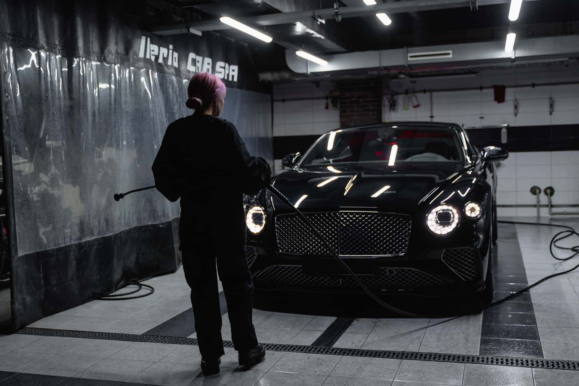 A clean, glossy car in a garage under cool light